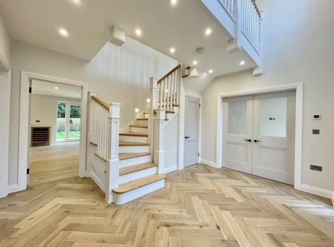 Elegant oak cut string staircase in a bright contemporary hallway
